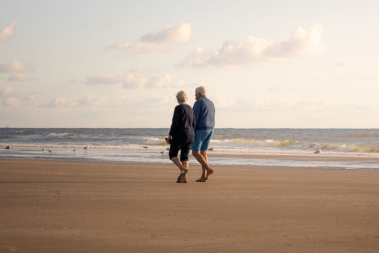 Couple partner and survivor walking on beach