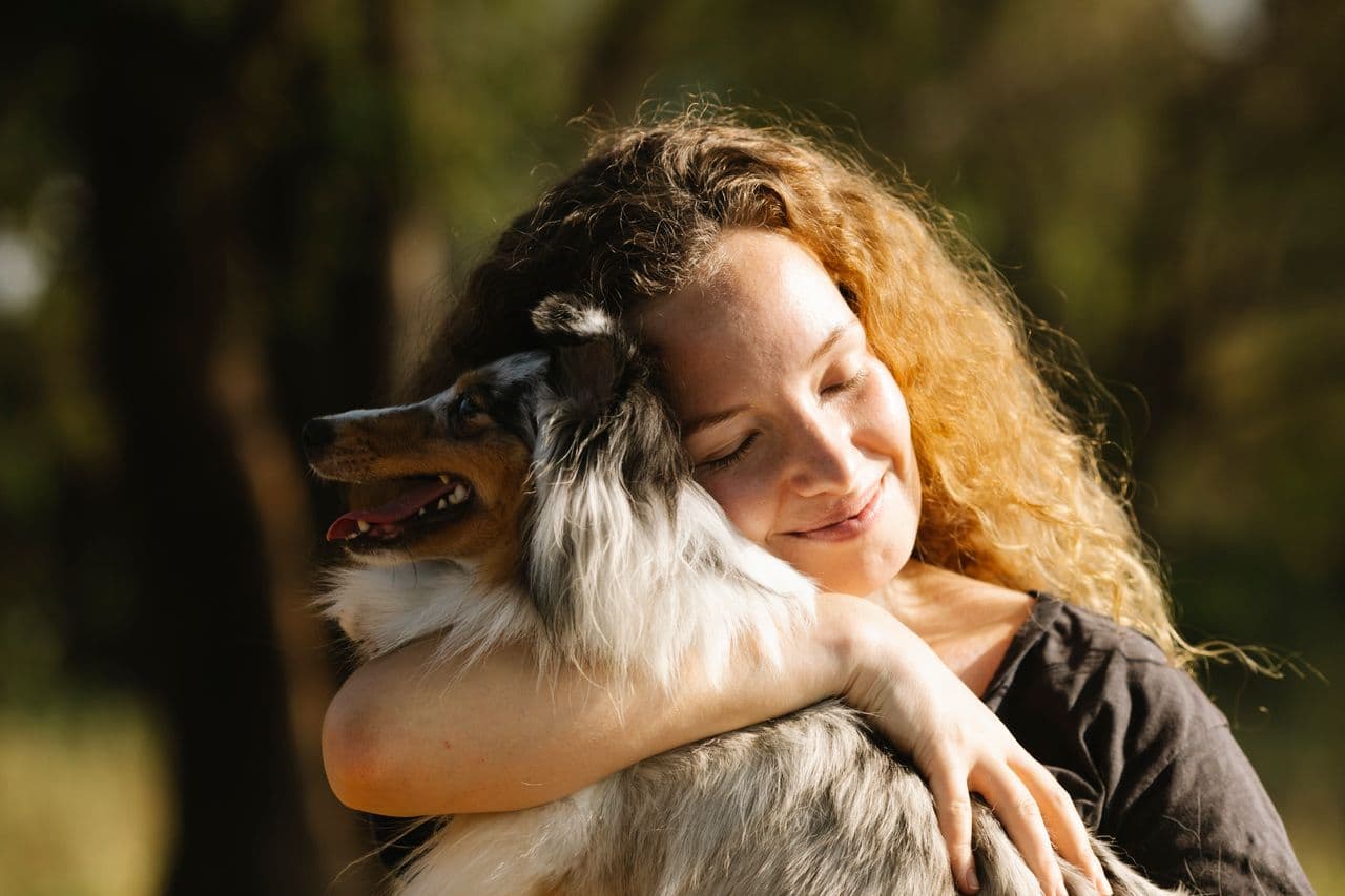 Woman survivor hugging her dog