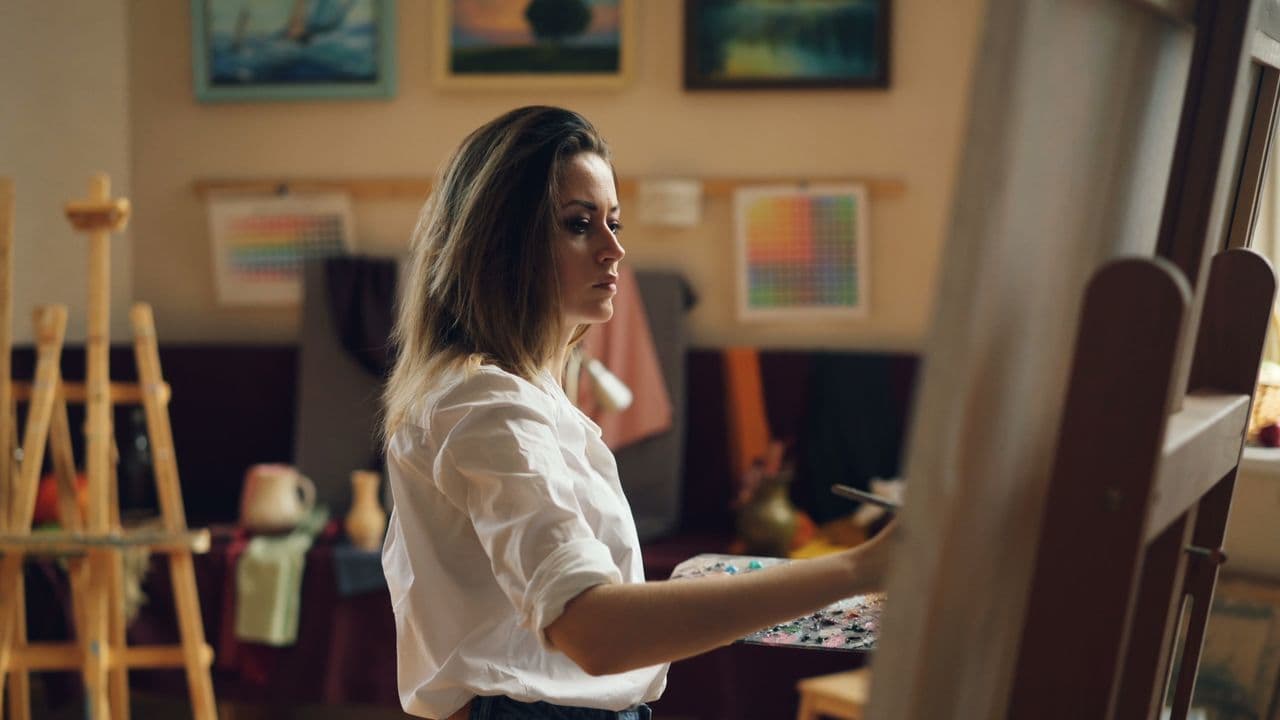 Woman painting as part of her self care