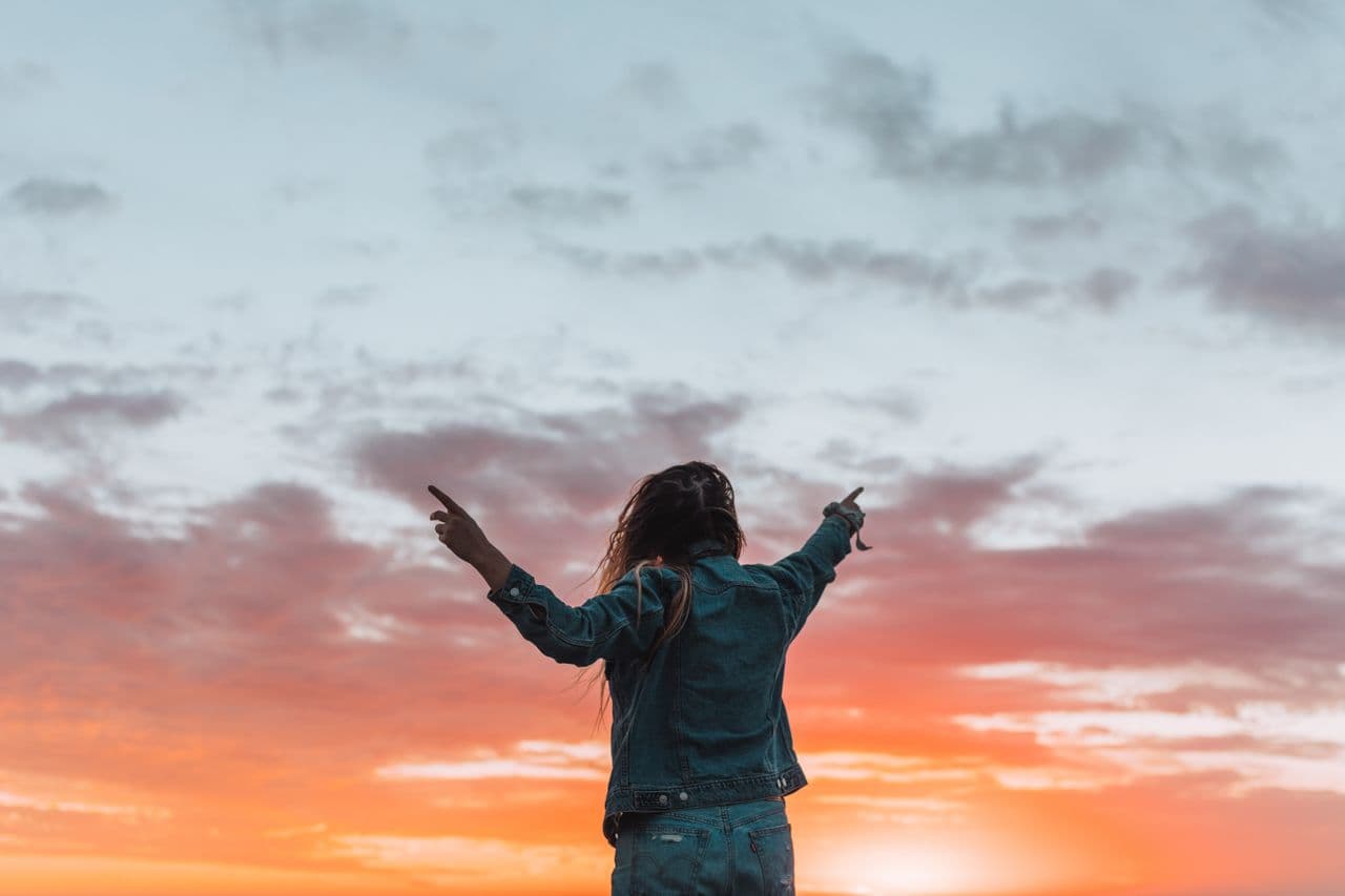Woman welcoming changes at dawn